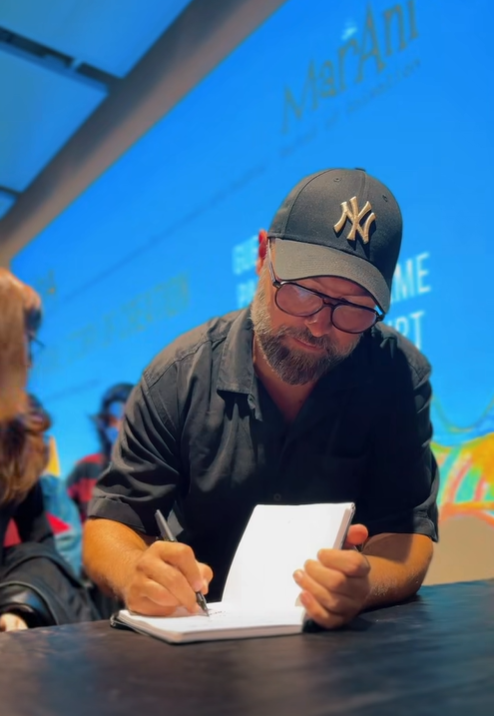 Pascal Charrue, co-director of Arcane at Fortiche, signing book.