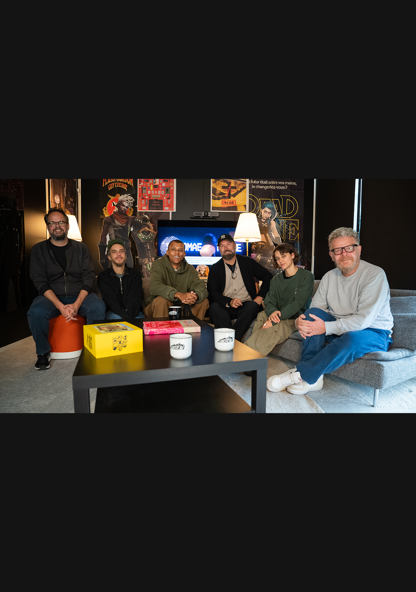 Stromae, Pomme, and the Fortiche Production founders posing together at the studio to celebrate the anniversary of Ma Meilleure Ennemie