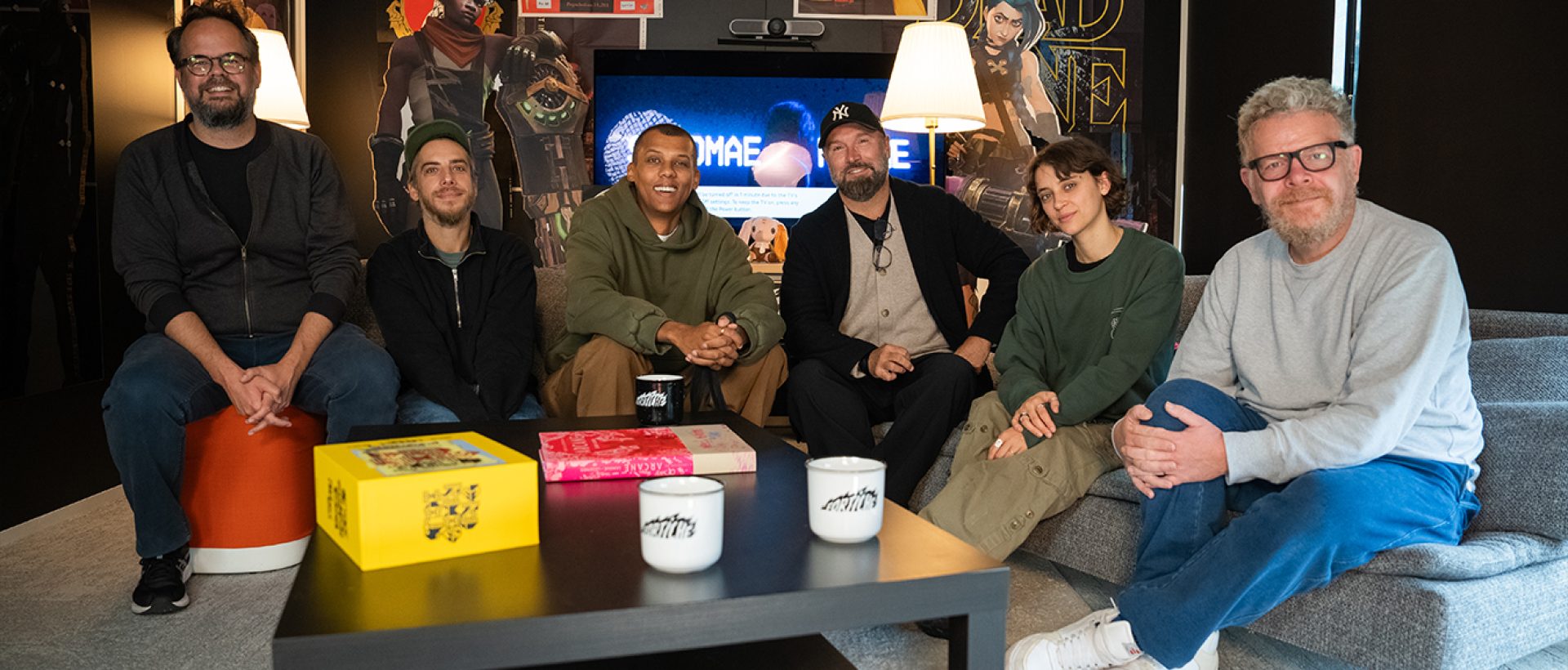 Stromae, Pomme, and the Fortiche Production founders posing together at the studio to celebrate the anniversary of Ma Meilleure Ennemie